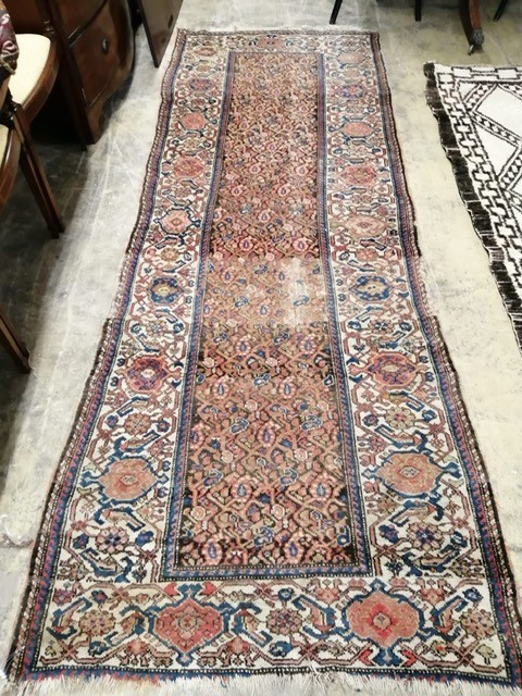 A Persian black ground runner, the central field including boteh motifs, 280 x 106cm, worn